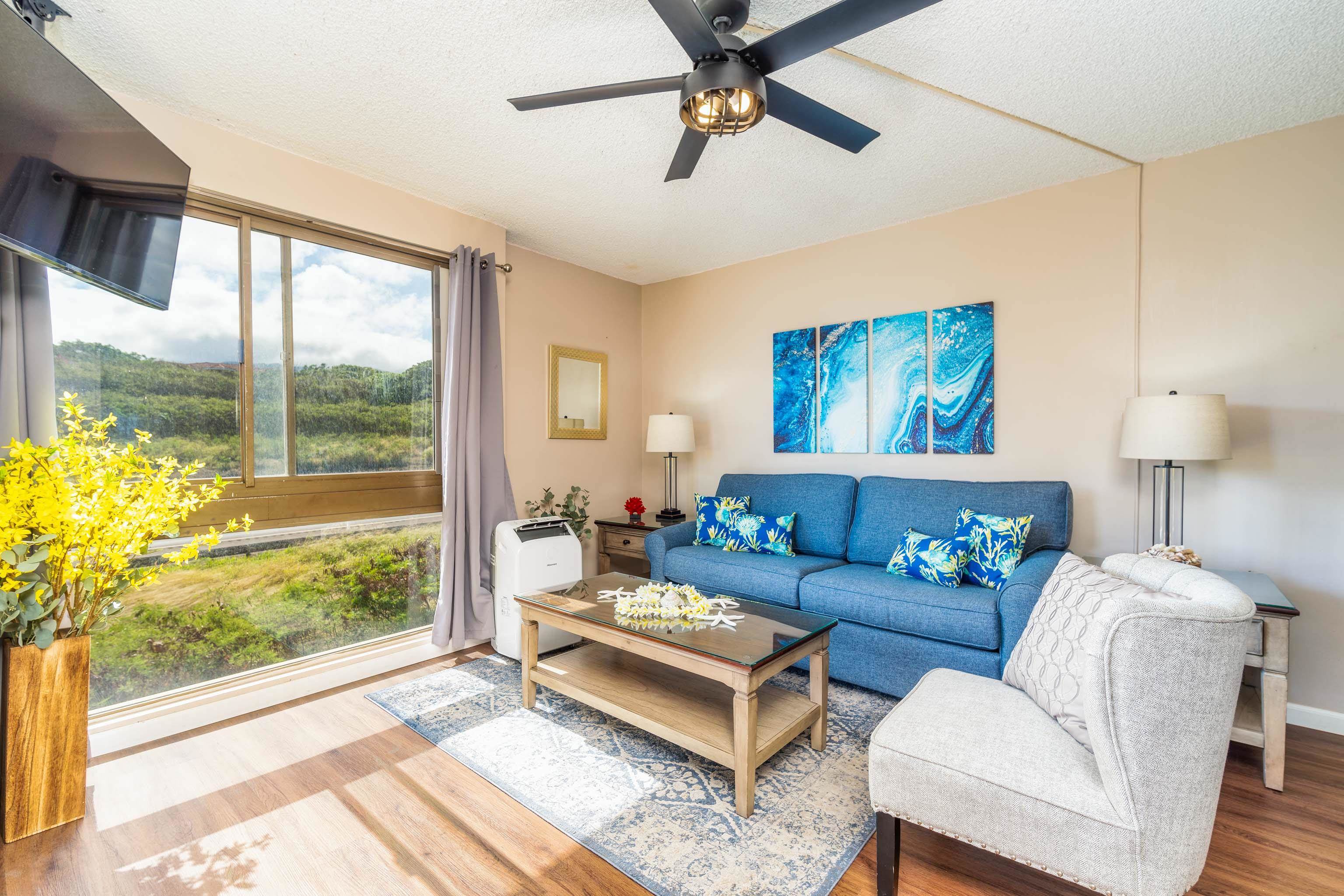 4310 Lower Honoapiilani Road, Unit 418 Lahaina, HI 96761 - Photo 6 of 31 a living room with furniture and a floor to ceiling window