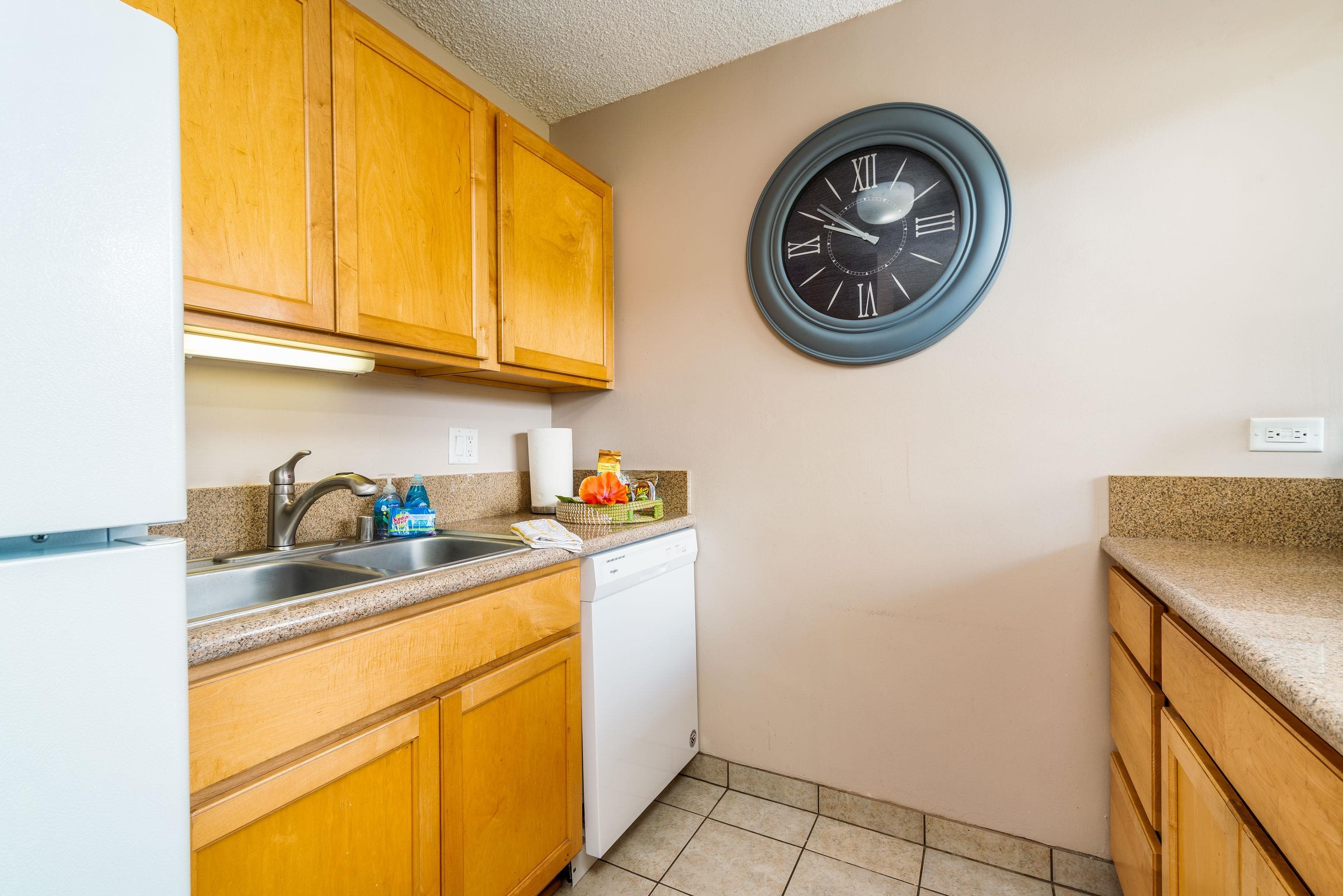 4310 Lower Honoapiilani Road, Unit 418 Lahaina, HI 96761 - Photo 10 of 31 a kitchen with stainless steel appliances granite countertop a sink and a microwave