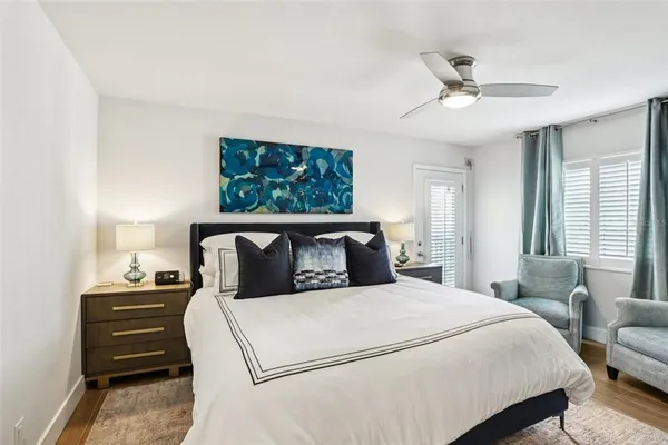 a bedroom with a large bed and a chandelier