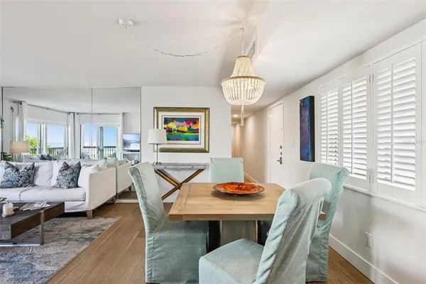 a living room with furniture a dining table and a window