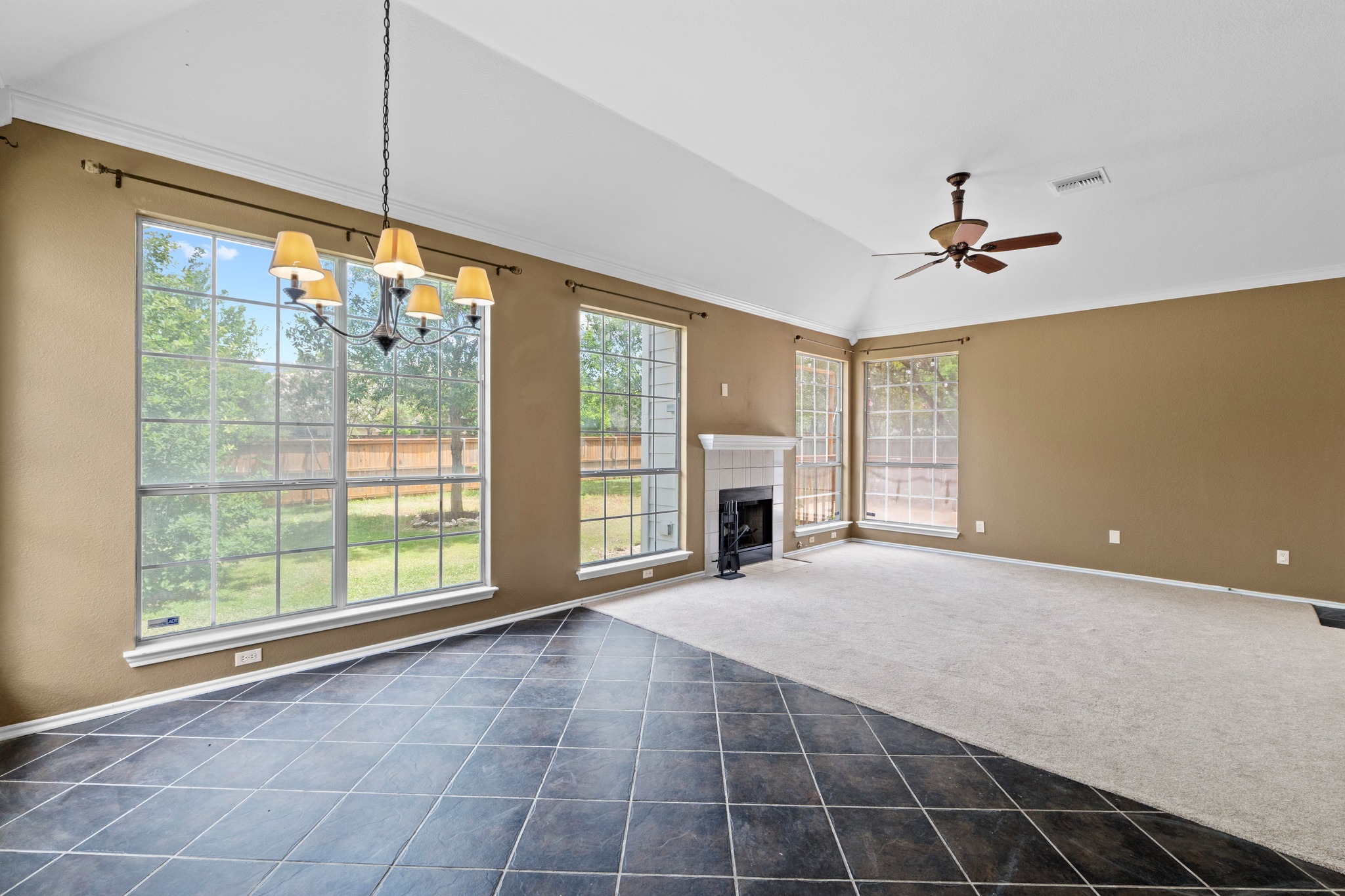 8605 Axis Drive Austin, TX 78749 - Photo 11 of 38 A spacious room offers vaulted ceilings, a cozy fireplace, and abundant natural light.