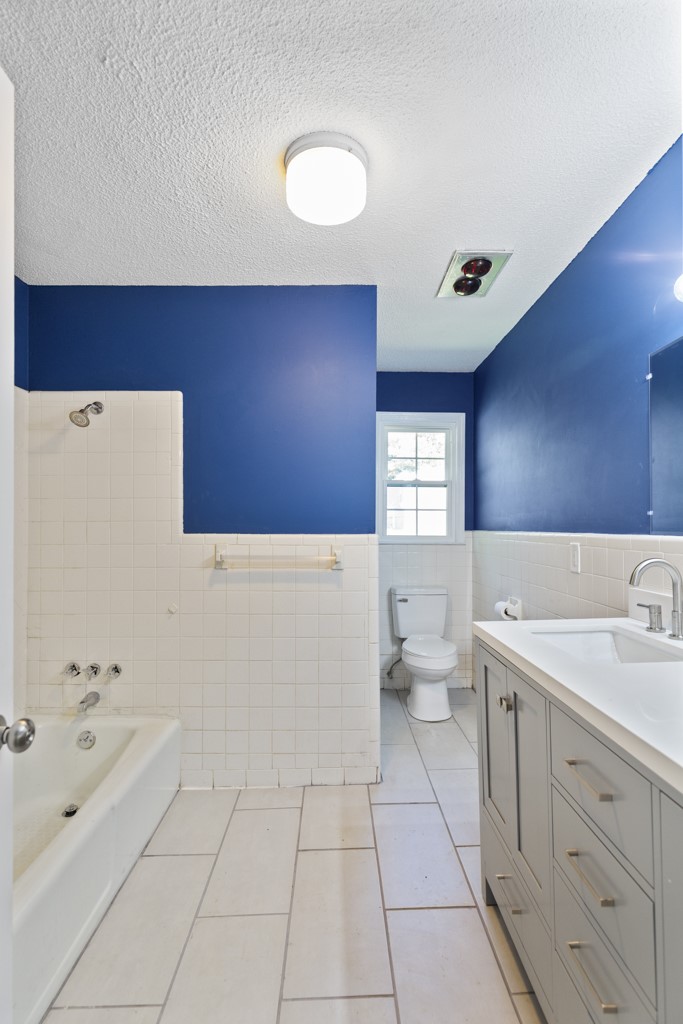 104 Doyle Drive Seneca, SC 29678 - Photo 10 of 19 This bathroom features vibrant blue walls and classic white tiling, creating a refreshing atmosphere.