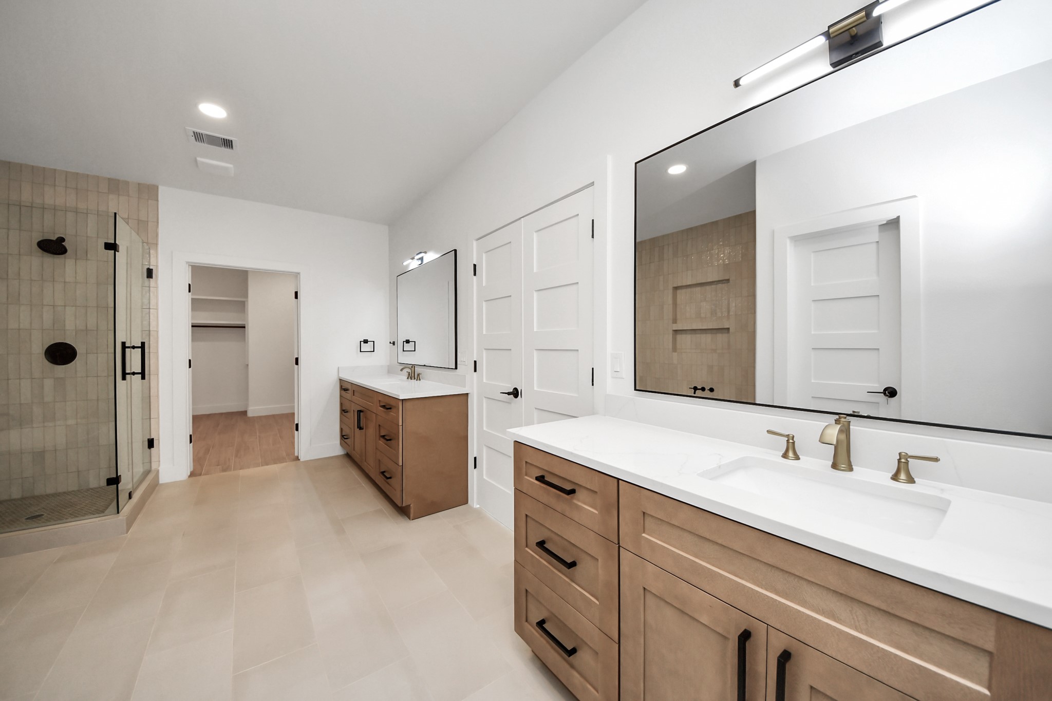 5811 County Road 675B Rosharon, TX 77583 - Photo 21 of 39 a spacious bathroom with a shower sink double vanity and mirror