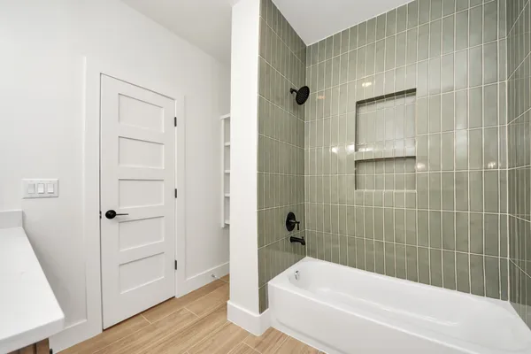 a bathroom with a bathtub and a shower