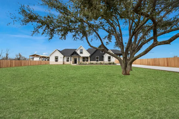 a view of a house with garden and sitting area