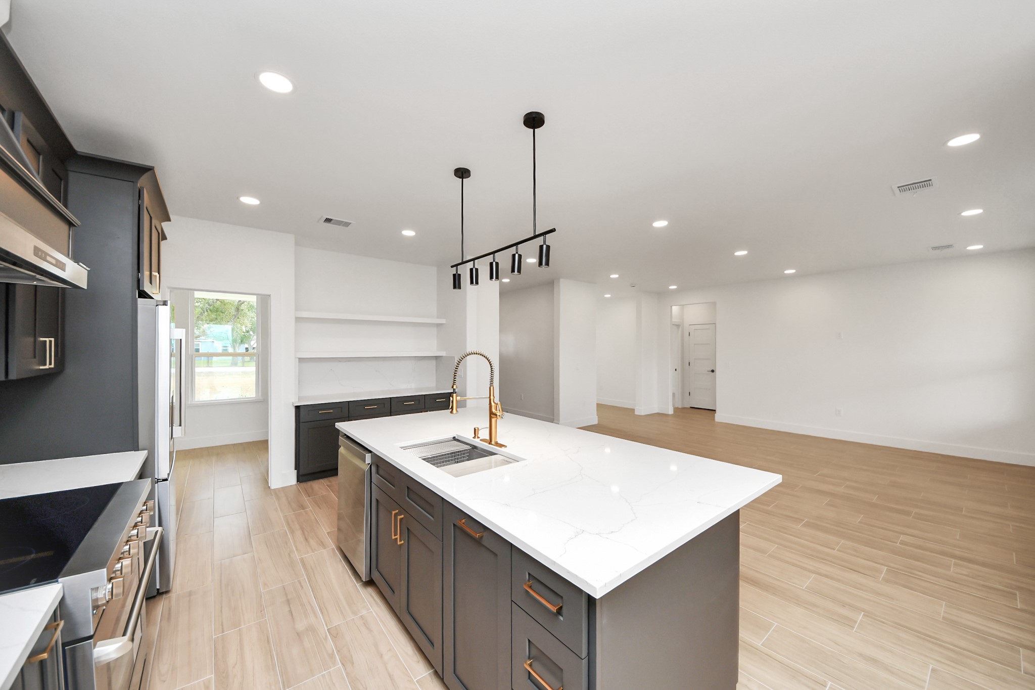 5811 County Road 675B Rosharon, TX 77583 - Photo 7 of 39 a kitchen with a sink a counter top space stainless steel appliances and wooden floor