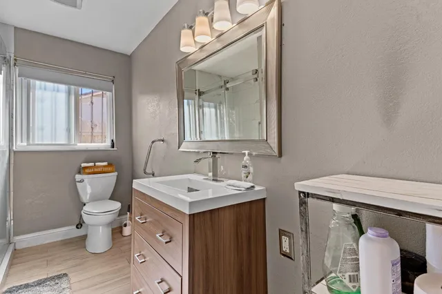 a bathroom with a sink toilet and mirror