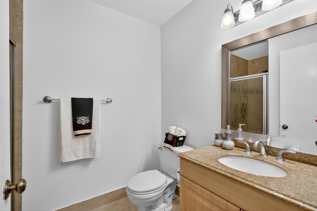 13930 Nesting Way, Unit C Delray Beach, FL 33484 - Photo 20 of 41 a bathroom with a granite countertop toilet a sink and mirror