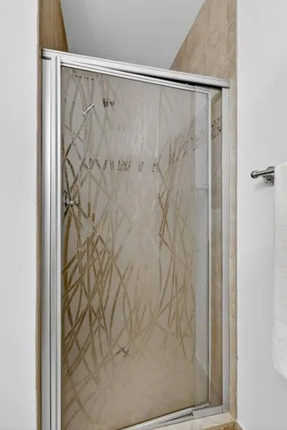 a bathroom with a shower curtain and a window