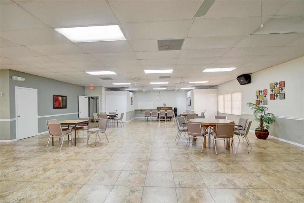 13930 Nesting Way, Unit C Delray Beach, FL 33484 - Photo 34 of 41 a group of people sitting in a living room