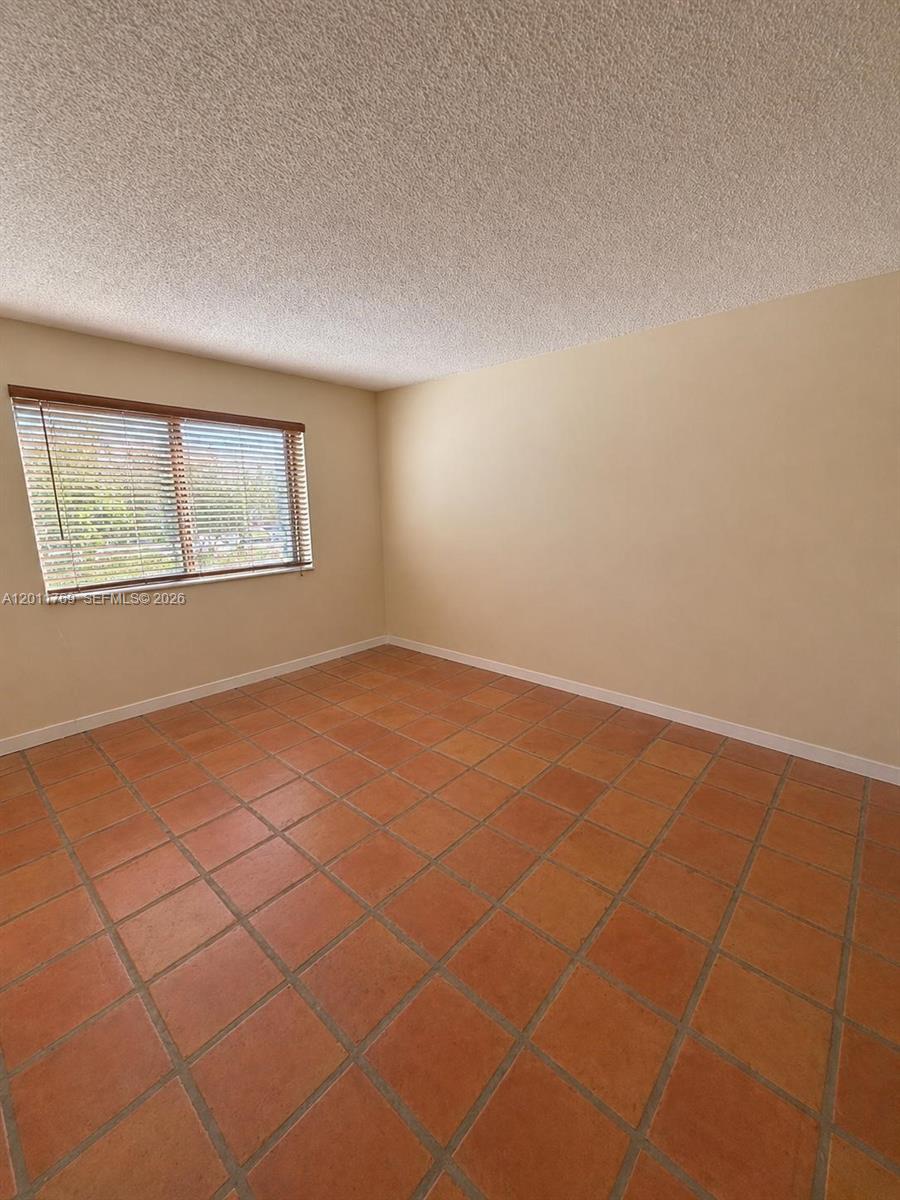 286 Racquet Club Road, Unit 204 Weston, FL 33326 - Photo 6 of 11 a view of an empty room with a window