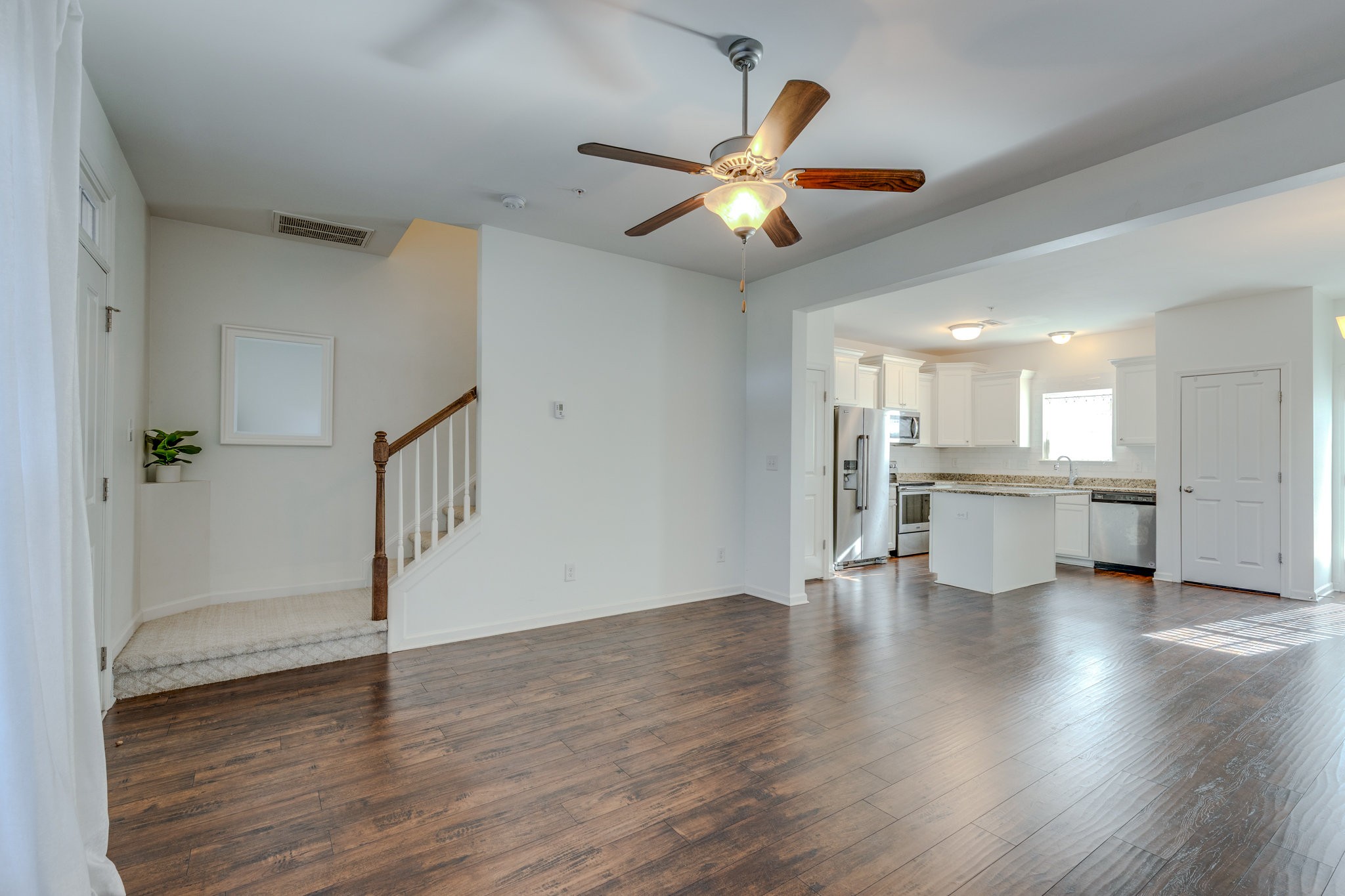 304 Oldbury Lane Spring Hill, TN 37174 - Photo 11 of 41 a view of an empty room with wooden floor and a ceiling fan