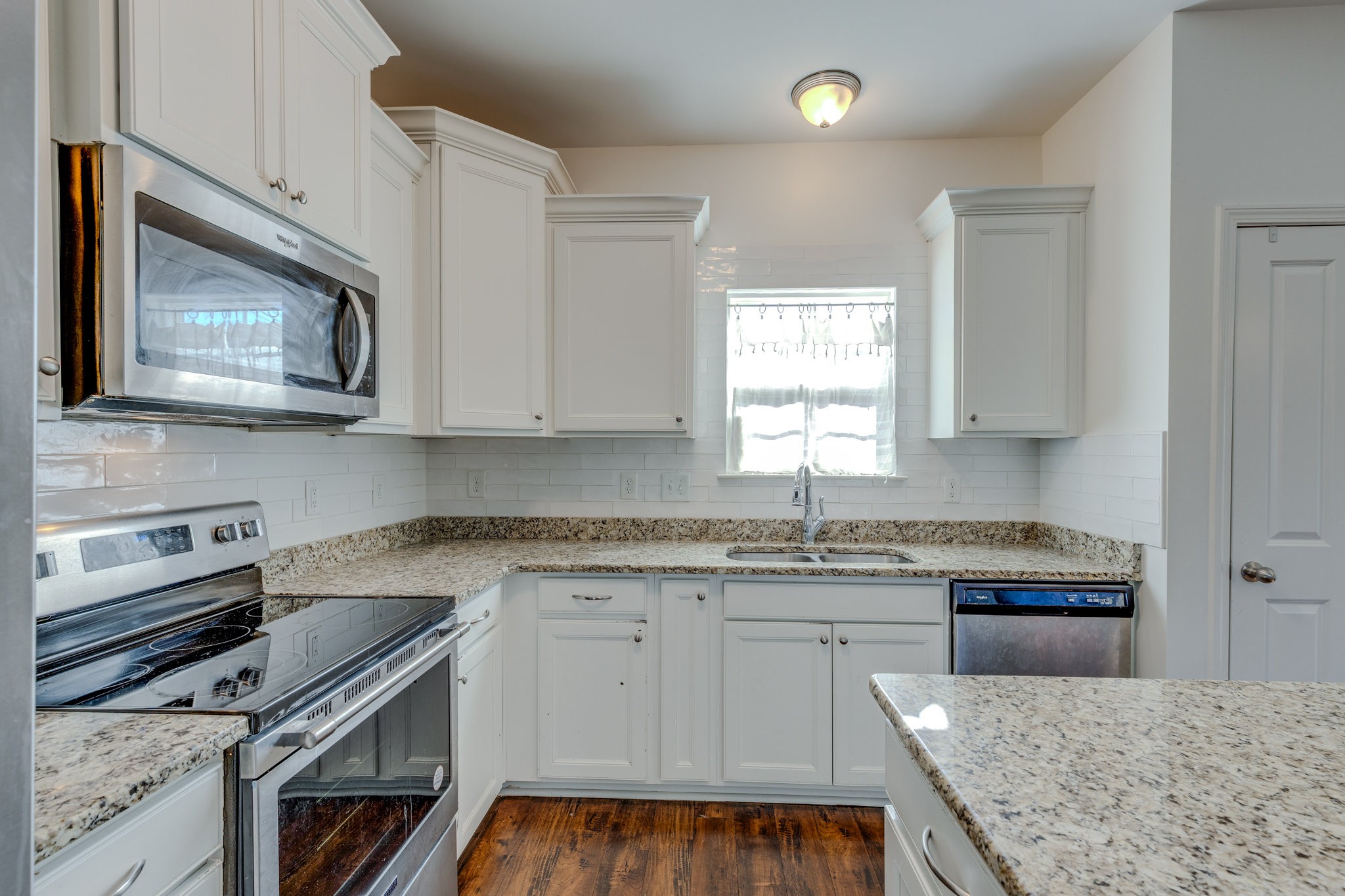 304 Oldbury Lane Spring Hill, TN 37174 - Photo 15 of 41 a kitchen with granite countertop a stove sink and microwave