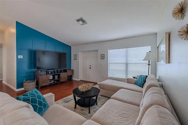 a living room with furniture and a flat screen tv