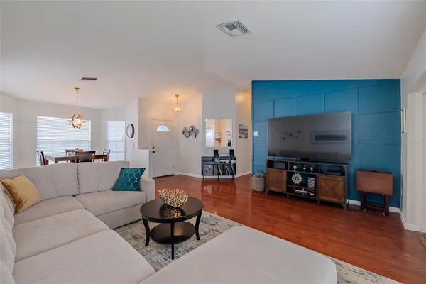 a living room with furniture and a flat screen tv