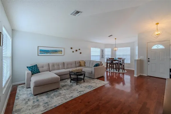 a living room with furniture and wooden floor