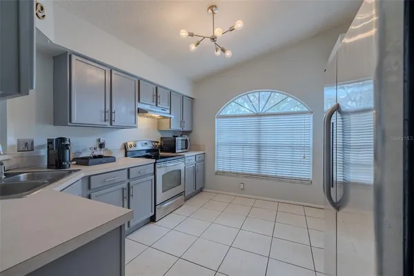 a kitchen with a refrigerator a sink and a stove