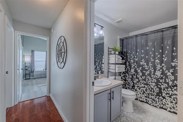 a bathroom with a toilet a sink and shower