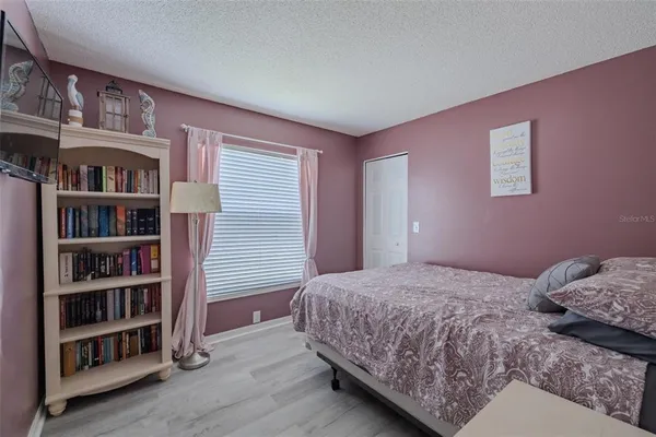 a bedroom with a bed and a book shelf