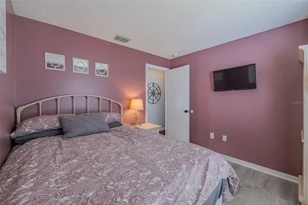 a bedroom with a bed and a flat screen tv