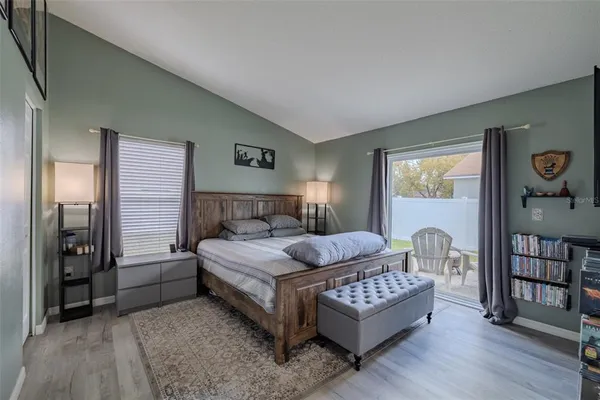 a bedroom with a bed couch and a window