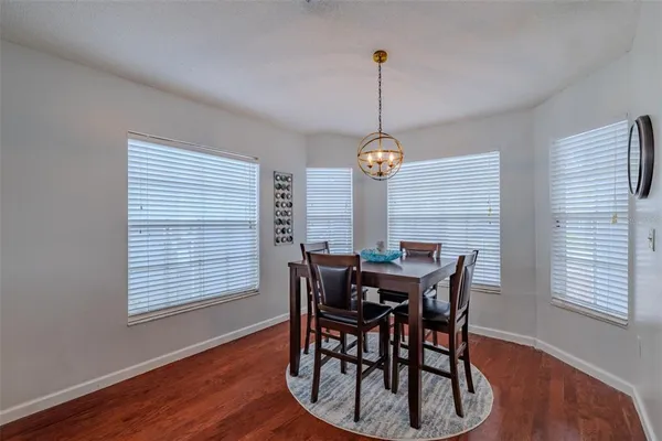 a view of a dining room with furniture window and wooden floor
