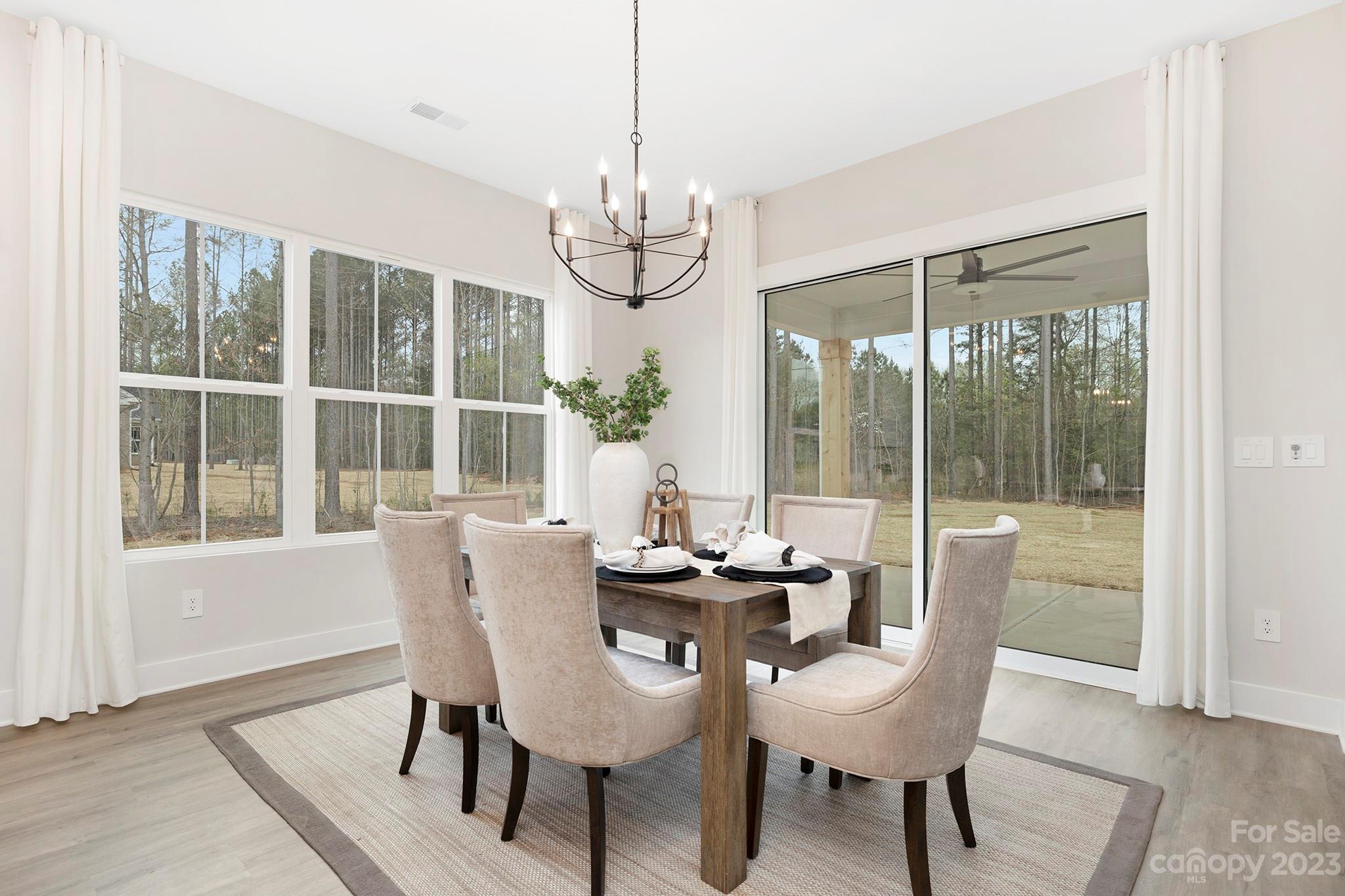 2404 Lee Lawing Road Lincolnton, NC 28092 - Photo 11 of 25 a dining room with furniture a chandelier and wooden floor
