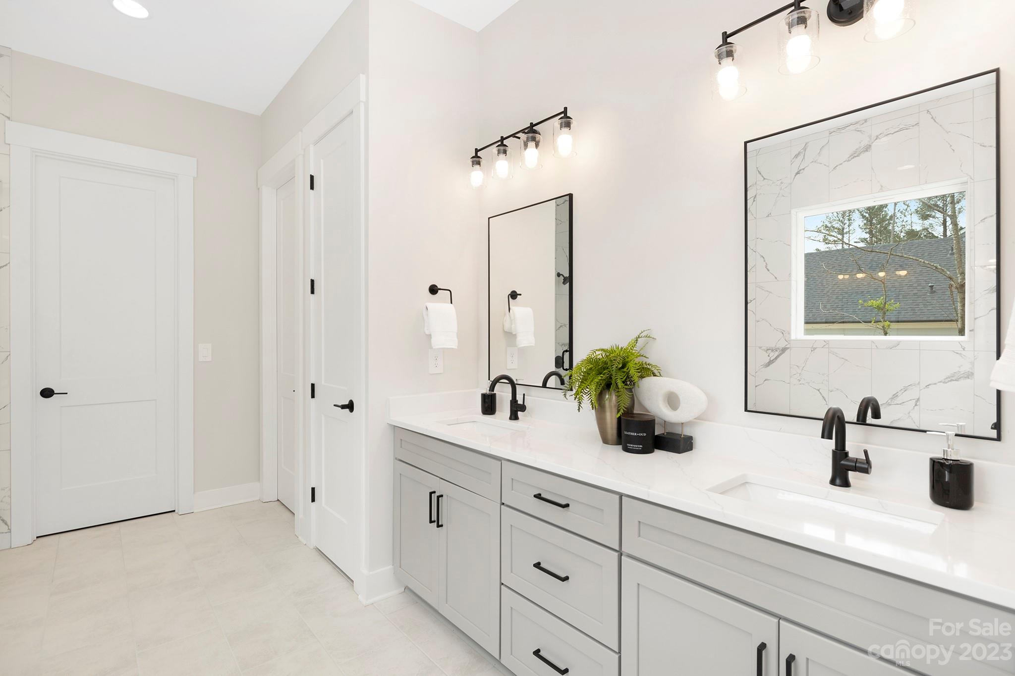 2404 Lee Lawing Road Lincolnton, NC 28092 - Photo 16 of 25 a bathroom with a double vanity sink mirror and next to a window