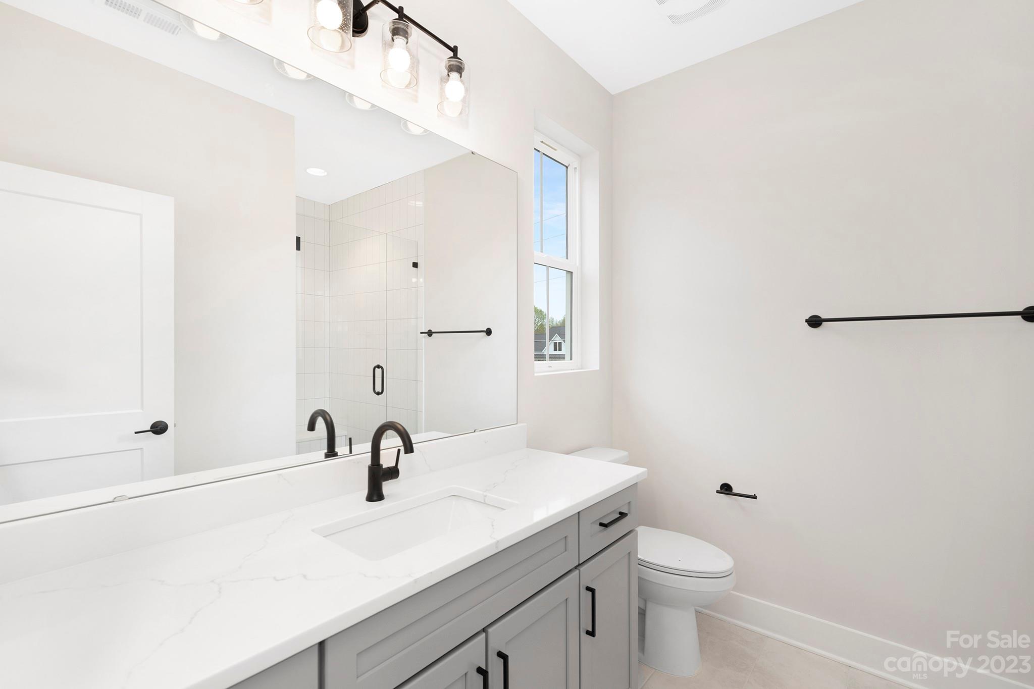 2404 Lee Lawing Road Lincolnton, NC 28092 - Photo 20 of 25 a view of bathroom with a sink mirror and toilet