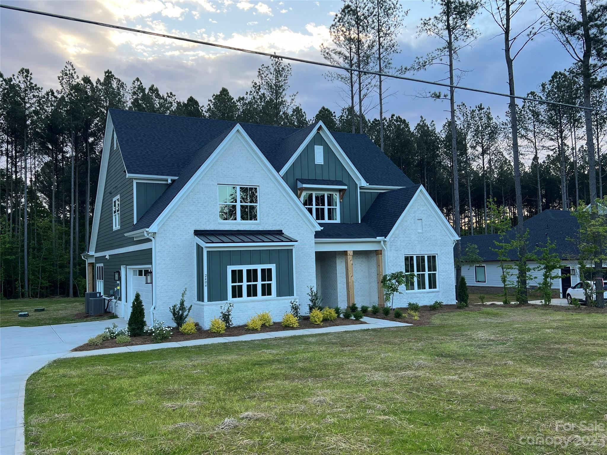 2404 Lee Lawing Road Lincolnton, NC 28092 - Photo 2 of 25 a front view of a house with a garden and yard