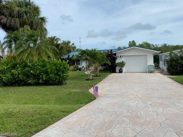 172 Riverwood Road Naples, FL 34114 - Photo 1 of 49 a view of a house with a yard and potted plants
