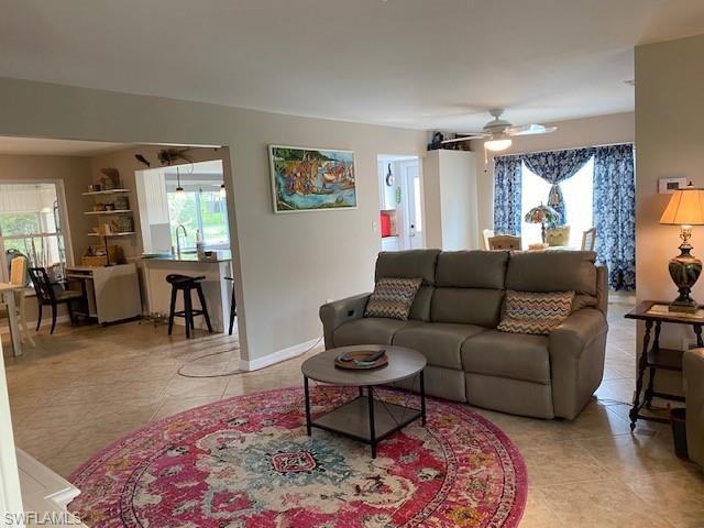 172 Riverwood Road Naples, FL 34114 - Photo 12 of 49 a living room with furniture and a large window