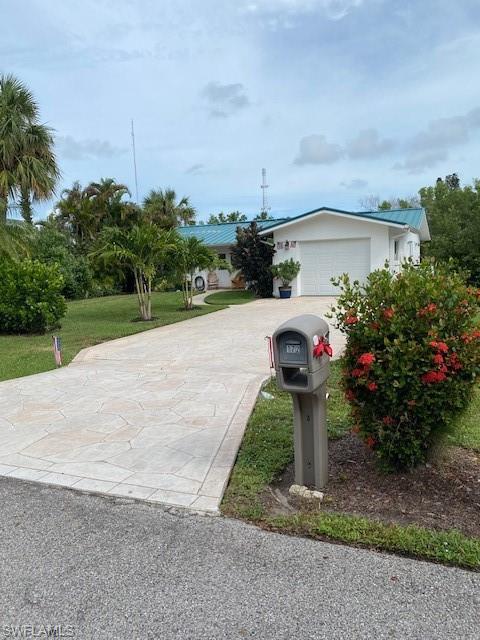 172 Riverwood Road Naples, FL 34114 - Photo 2 of 49 a view of a garden with potted plants