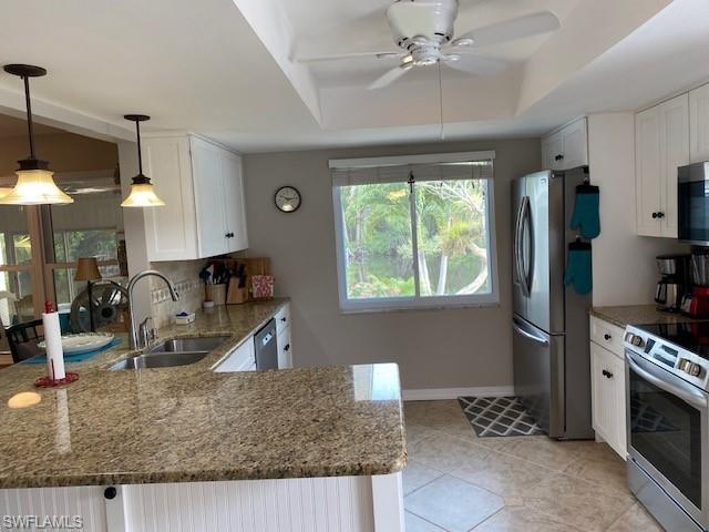 172 Riverwood Road Naples, FL 34114 - Photo 23 of 49 a kitchen with stainless steel appliances granite countertop a sink a stove and a refrigerator