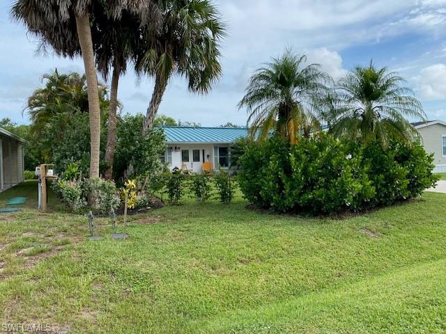 172 Riverwood Road Naples, FL 34114 - Photo 3 of 49 a view of a garden with a house