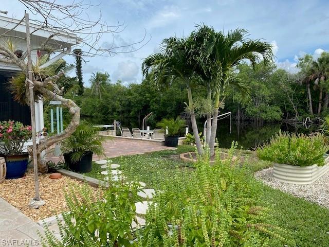 172 Riverwood Road Naples, FL 34114 - Photo 43 of 49 a view of a house with backyard and sitting area