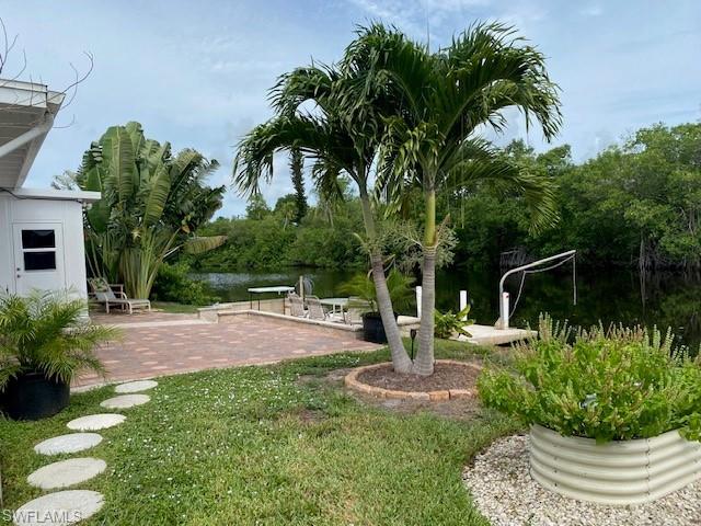 172 Riverwood Road Naples, FL 34114 - Photo 44 of 49 a view of a chair and table in backyard of the house