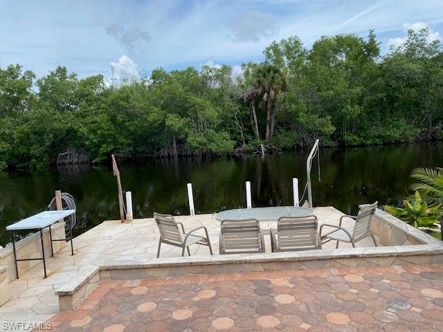 172 Riverwood Road Naples, FL 34114 - Photo 48 of 49 a view of a lake with a bench