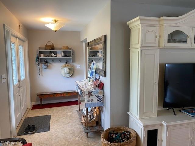 172 Riverwood Road Naples, FL 34114 - Photo 10 of 49 a living room with furniture and a flat screen tv