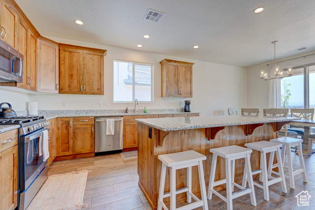 1329 Paseos Street Washington, UT 84780 - Photo 6 of 35 Kitchen featuring stainless steel appliances, recessed lighting, a kitchen breakfast bar, a kitchen island, and a chandelier