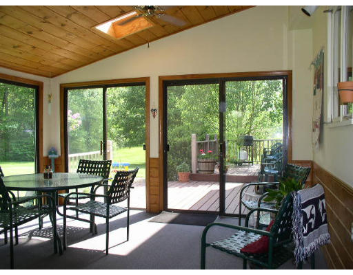 152 Flagg Hill Road Boxborough, MA 01719 - Photo 8 of 11 a view of a dining room with furniture large windows and wooden floor