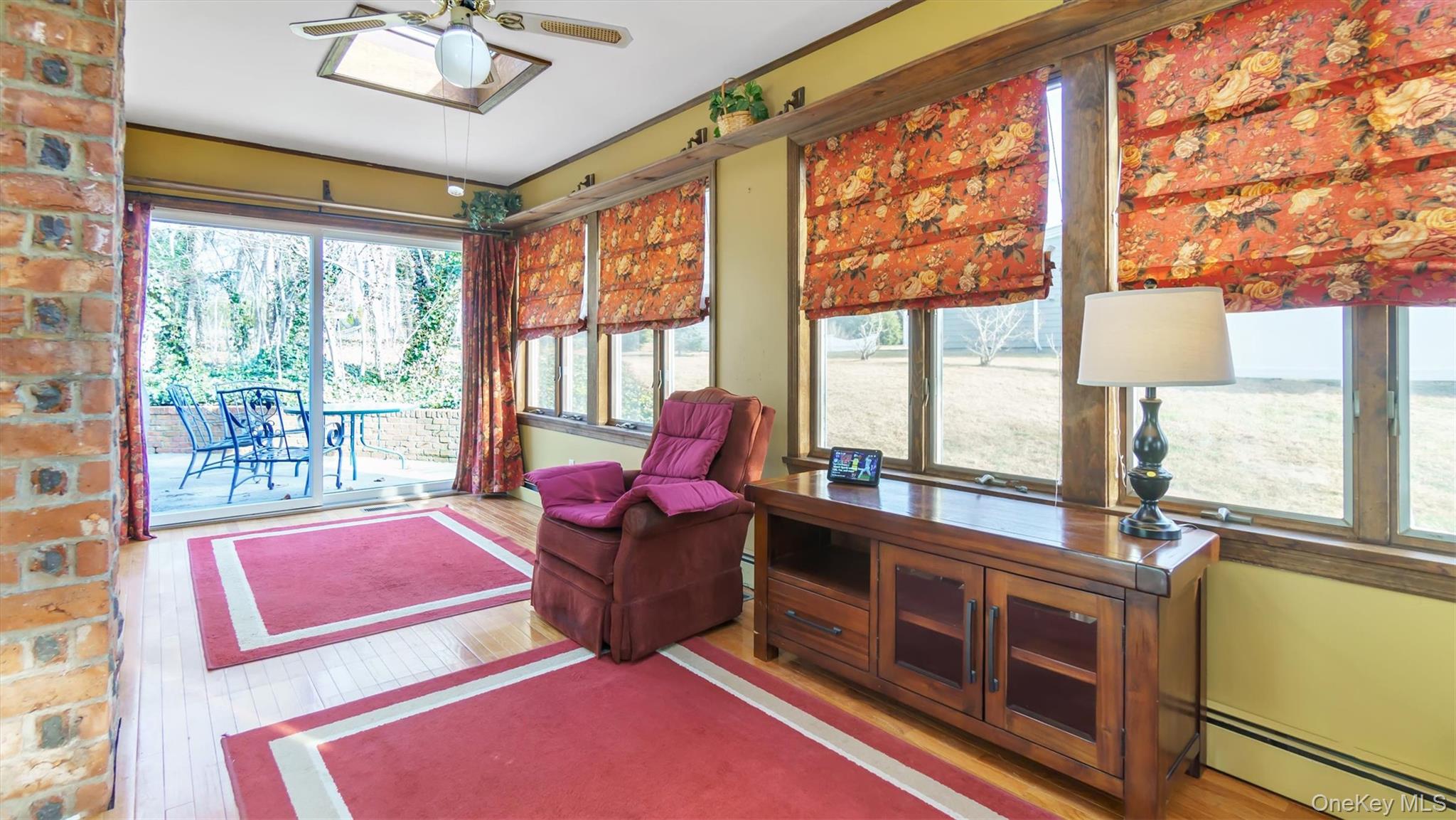 280 Wickham Avenue Mattituck, NY 11952 - Photo 11 of 41 a living room with furniture and a floor to ceiling window
