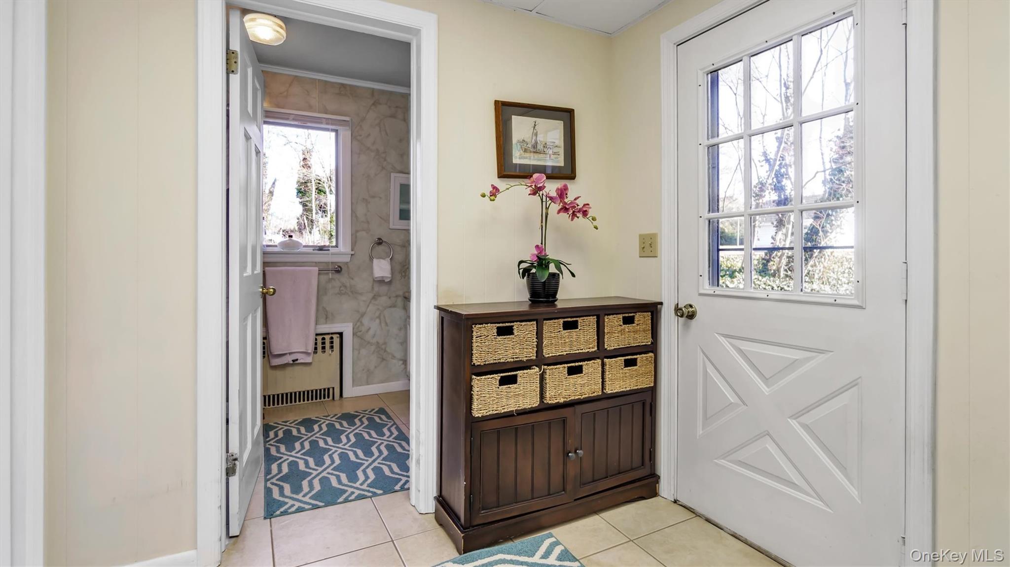 280 Wickham Avenue Mattituck, NY 11952 - Photo 15 of 41 a view of an entryway with wooden floor and cabinet