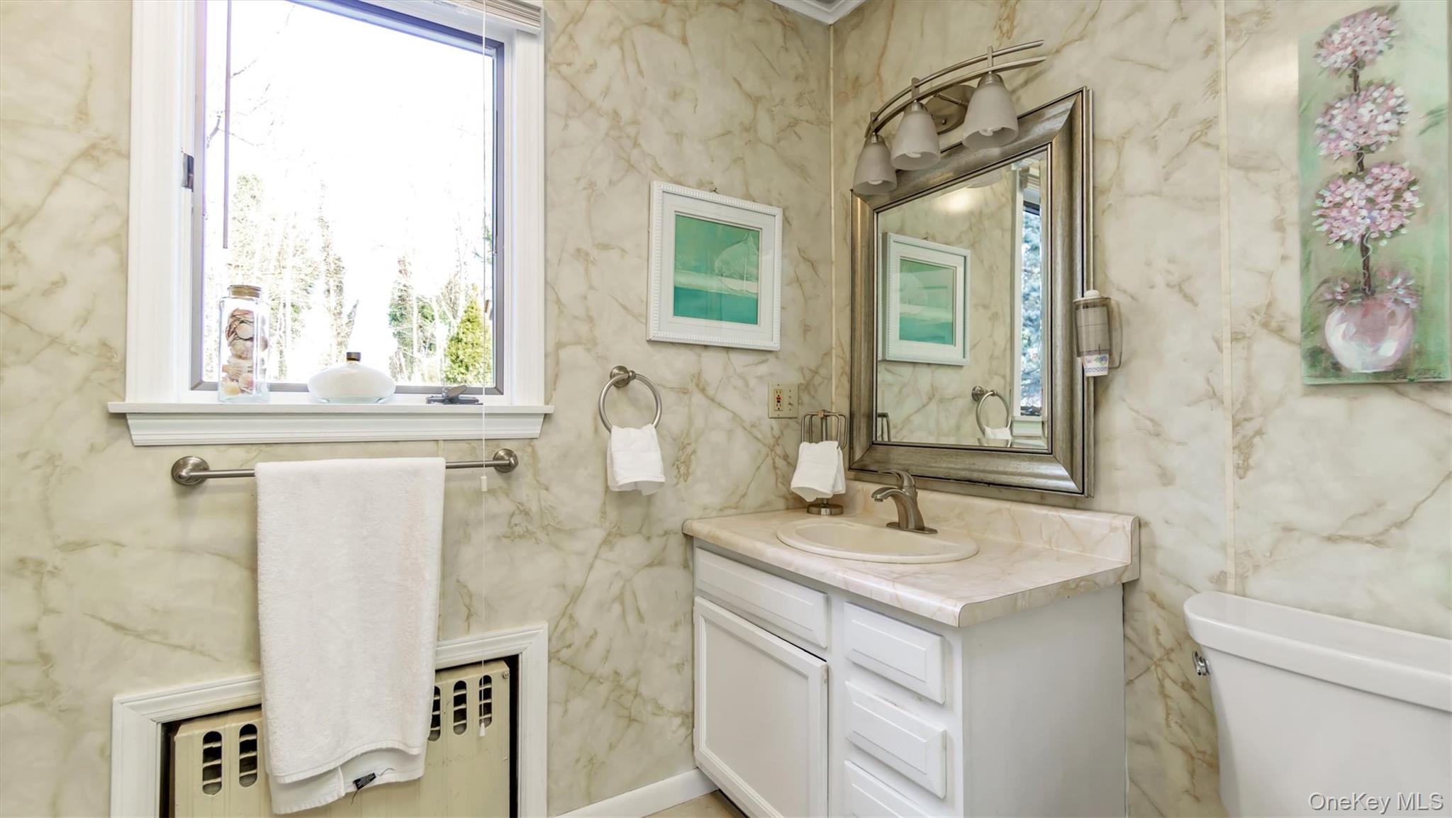 280 Wickham Avenue Mattituck, NY 11952 - Photo 16 of 41 a bathroom with a sink and a mirror