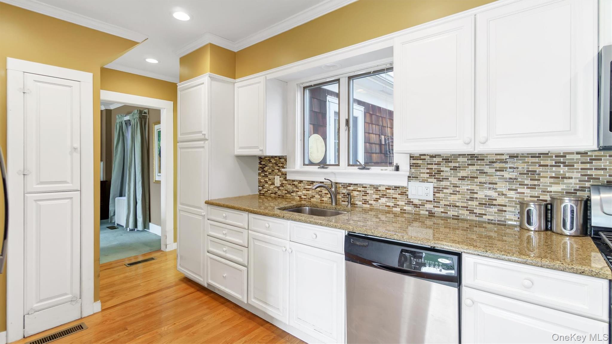 280 Wickham Avenue Mattituck, NY 11952 - Photo 21 of 41 a kitchen with granite countertop a sink and cabinets