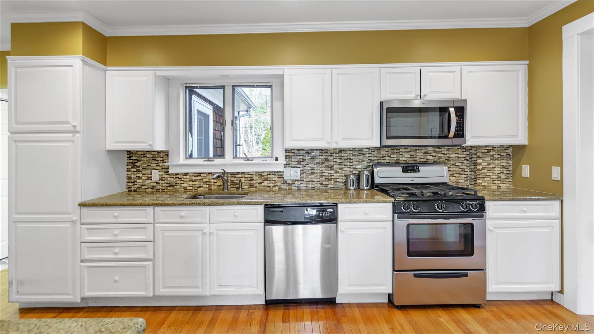 280 Wickham Avenue Mattituck, NY 11952 - Photo 23 of 41 a kitchen with stainless steel appliances granite countertop a stove a sink and a microwave