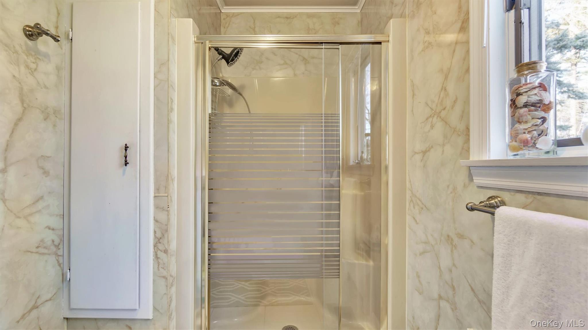 280 Wickham Avenue Mattituck, NY 11952 - Photo 25 of 41 a bathroom with a glass shower door