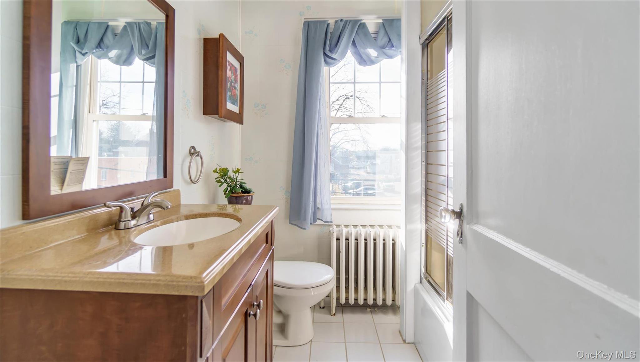 280 Wickham Avenue Mattituck, NY 11952 - Photo 29 of 41 a bathroom with a sink a toilet and a window