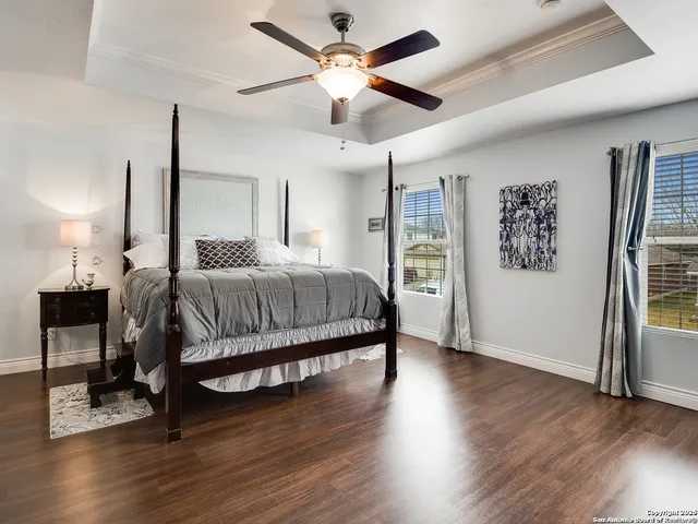 a bedroom with a bed chandelier and a window