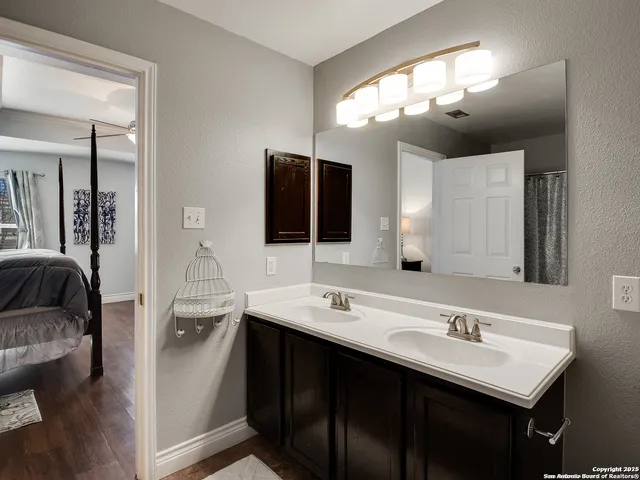 a bathroom with a sink double vanity and a mirror